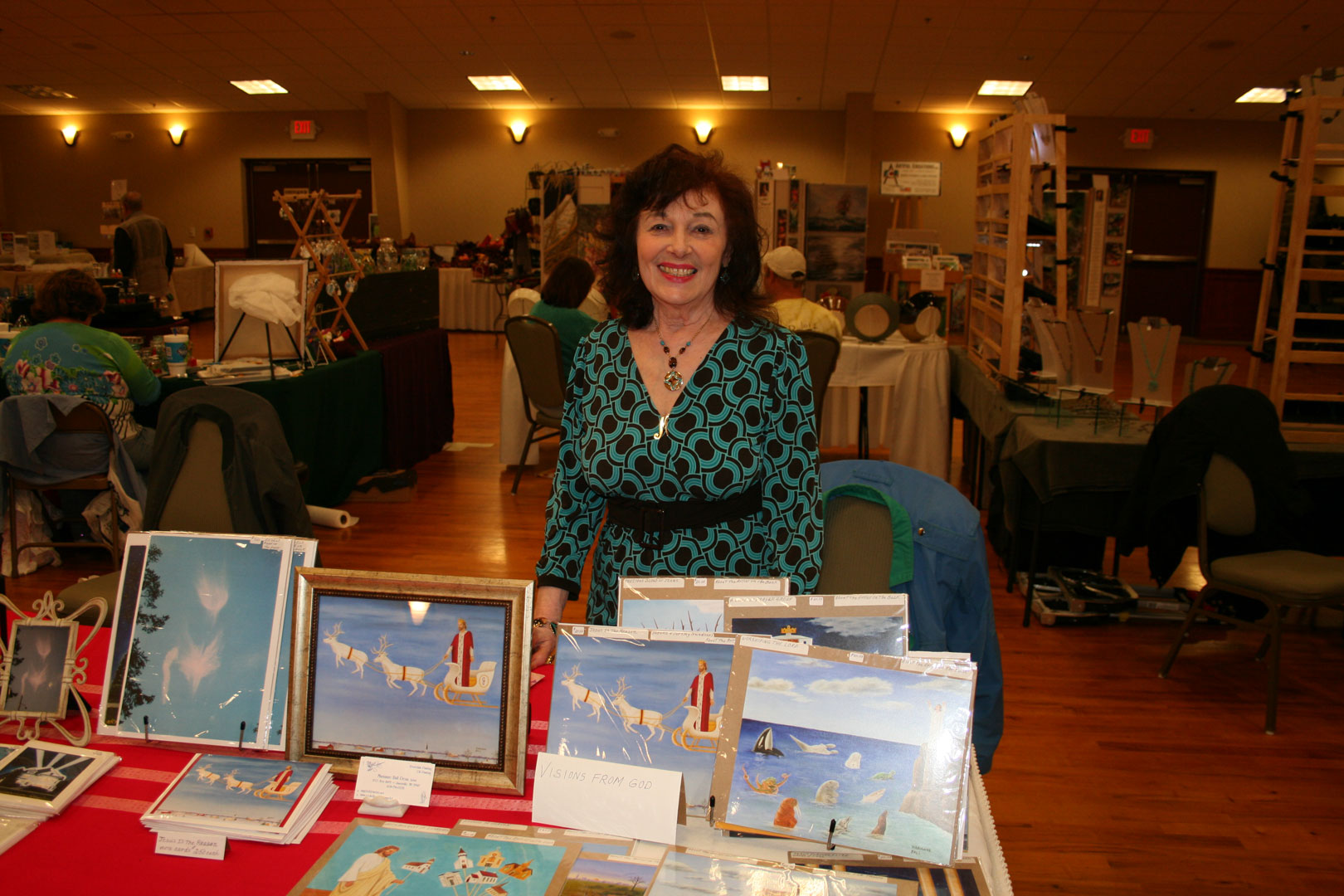 Marianne Ball at her display booth, surrounded by her angel paintings and cards