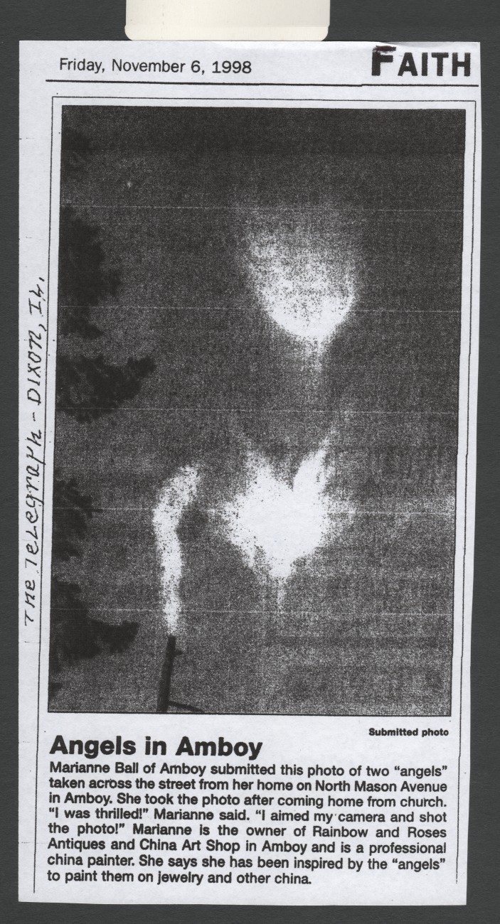 Newspaper clipping dated Friday, November 6, 1998, headed Angels in Amboy, showing a black and white photograph of two winged cloud shapes above a utility pole.